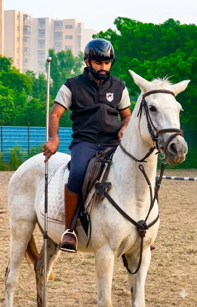 A tent-pegging rider holding a lance on a grey horse at FHRC, Faridabad.